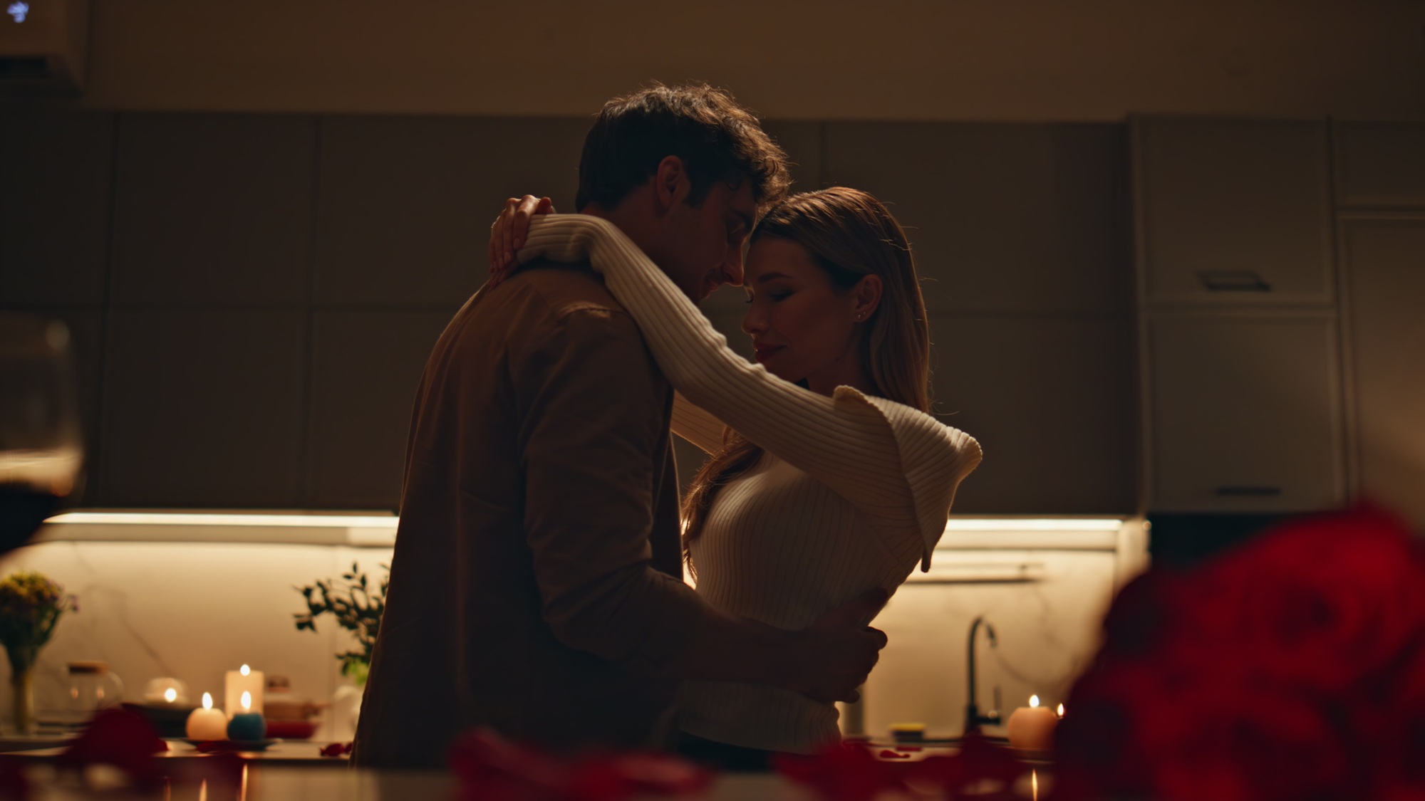 Romantic spouses dancing kitchen feeling closeness close up. Couple evening date
